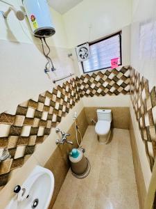a bathroom with a sink and a toilet at Olive By David Residency - Just 4 Kms from Meenakshi Amman Temple in Madurai