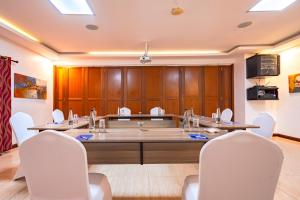 a conference room with a large table and white chairs at PrideInn Hotel Nyali in Mombasa