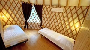 a room with two beds in a yurt at Gîte Les yourtes de Saint Mathieu N°1 in Saint-Mathieu