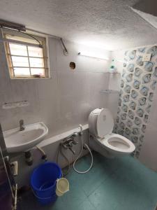 a bathroom with a toilet and a sink at SK INN stays in Mahabalipuram