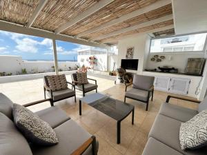a living room with a couch and chairs at Hill Penthouse Plett - Best On Top in Plettenberg Bay