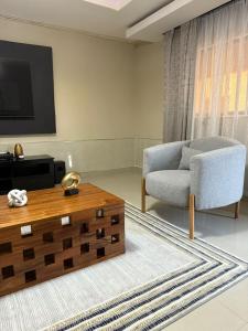 a living room with a couch and a coffee table at Sazeesha Apartments in Ndola