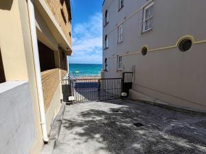 a view of the ocean from between two buildings at Ocean Blue Stay in St James