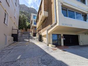 an empty street in front of a building at Ocean Blue Stay in St James