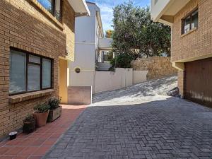 a brick alleyway next to a brick building at Ocean Blue Stay in St James