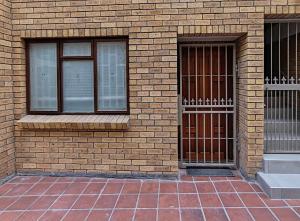 two windows on the side of a brick building at Ocean Blue Stay in St James +45 photos