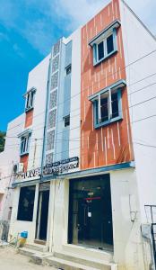 a building with a sign on the front of it at Olive By David Residency - Just 4 Kms from Meenakshi Amman Temple in Madurai