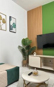 a room with a bed and a tv and a table at T2 Vacation in Mindelo in Mindelo