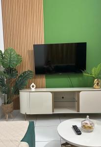 a living room with a flat screen tv on a wall at T2 Vacation in Mindelo in Mindelo