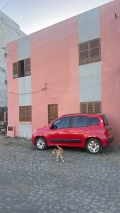 a red car parked in front of a building at T2 Vacation in Mindelo in Mindelo +13 photos
