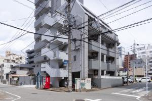 a tall gray building on a city street at 3 minutes walk from Minami Fukuoka Station, free Wi-Fi in Fukuoka