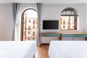 Ένα ή περισσότερα κρεβάτια σε δωμάτιο στο Mimosa Hotel Phú Quốc