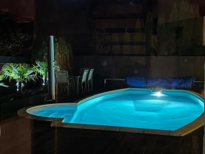 a large blue hot tub in a room with plants at Harmony Spa Matyldów in Matyldów