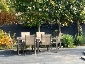 a table and chairs sitting under a tree at Harmony Spa Matyldów in Matyldów
