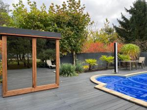 a wooden deck with a pavilion and a swimming pool at Harmony Spa Matyldów in Matyldów