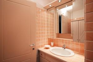 a bathroom with a sink and a mirror at Sardegna è - Beach Rooms LE in Olbia