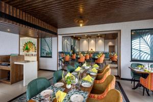 a dining room with long tables and chairs at ZIBE Luxe Hyderabad by GRT Hotels in Hyderabad