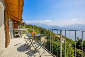 a table and chairs on the balcony of a house at Villa Graziosa in Trarego