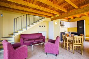 a living room with pink furniture and a table at Villa Graziosa in Trarego