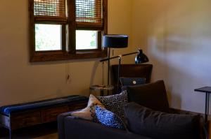 a living room with a couch and a lamp at Escalante Outfitters in Escalante