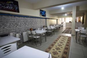 a restaurant with tables and chairs and a brick wall at OTEL 22 EDiRNE in Edirne