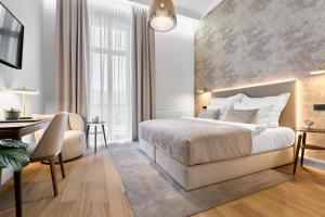 a hotel room with a bed and a desk at Villa Patriot Boutique Hotel in Mariánské Lázně