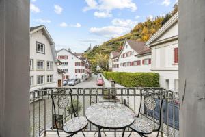 a balcony with a table and chairs on a street at Altstadtidyll am See 1 - 6 Personen I Ruhig - Balkon - Parkplatz - nahe Bahnhof und Autobahn in Weesen