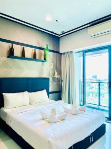 Ένα ή περισσότερα κρεβάτια σε δωμάτιο στο Summer Suites klcc by classy stay +72 φωτογραφίες