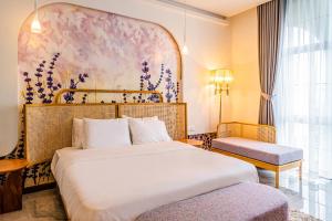 a hotel room with a bed and a painting on the wall at An Lac Hotel in Ho Chi Minh City