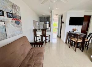 a living room with a couch and a table at The Sandy Pearl Apartment in Luquillo