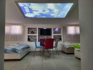 a room with two beds and a table and chairs at Home 22 Otel in Edirne