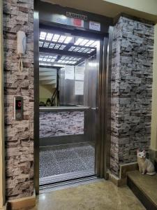 a cat sits in front of a revolving door at Home 22 Otel in Edirne