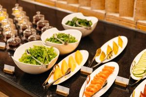 a buffet with plates of food on a table at Samovar in Petropavlovsk +48 photos