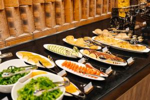 a buffet with many plates of food on a table at Samovar in Petropavlovsk