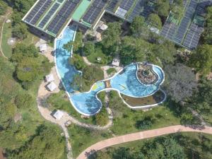 an overhead view of a pool in a garden with solar panels at Pristine Mara Bay Lodge in Masai Mara +26 photos