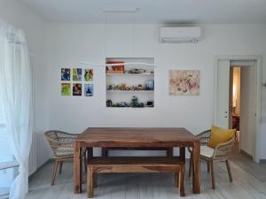 a dining room with a wooden table and chairs at Portion of a villa with a private pool in Ansedónia