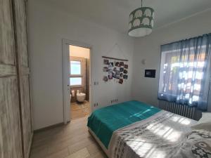 a bedroom with a bed with a green blanket at Portion of a villa with a private pool in Ansedónia +44 photos