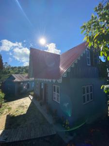 a house with the sun shining on the roof at Karfok Khalanga community homestay in Ilām