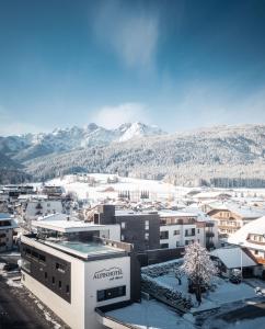 a view of a city with snow covered mountains at Alpinhotel Keil in Valdaora