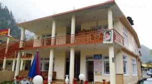 a large building with a balcony on top of it at Star Rise Hotel in Naran