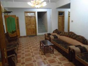 a living room with a couch and a table at Star Rise Hotel in Naran