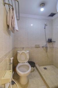 a bathroom with a toilet and a shower at 2BR Apartment Majesty W Pool in Bandung