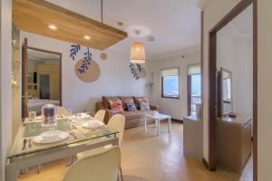 a living room with a table and some chairs at 2BR Apartment Majesty W Pool in Bandung +14 photos