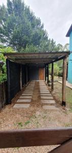 a covered walkway with a building with a door at Hermosa casa con piscina en Bella Vista Piriápolis a 2 c de la playa in Bella Vista +6 photos