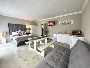 a large bedroom with a bed and a couch at OR Tambo Stay Unit 1 in Boksburg
