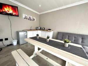 a living room with a table and a couch at OR Tambo Stay Unit 1 in Boksburg +5 photos
