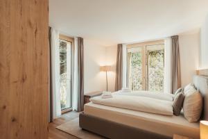 Postel nebo postele na pokoji v ubytování San Bernardino Alpine Apartments