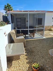a house with a patio with a table and chairs at Casa Sol y Luna in Arboleas