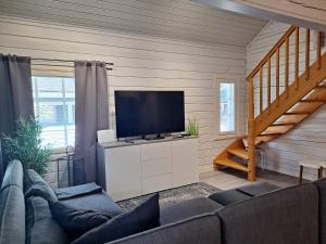 a living room with a couch and a flat screen tv at Lusseeri in Kalajoki