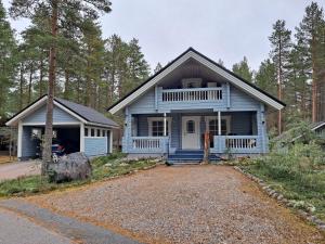 a blue house in the middle of a forest at Lusseeri in Kalajoki